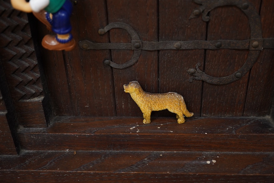 A carved oak firescreen in form of a Norman Romanesque church door and frontage Height 69cm. Width 62cm. Condition - fair